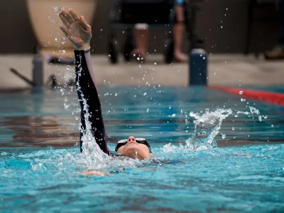 Annalysa Lovos, a member of the University of Arizona Para swim team practices her backstroke at the Student Recreation Center Pool