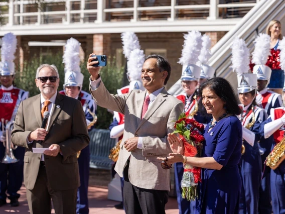 President Suresh Garimella takes a selfie with his wife, Lakshmi, in front of Old Main during an event welcoming him to campus.