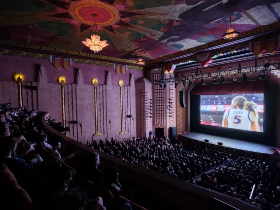 people sitting in a dark theater watching a film