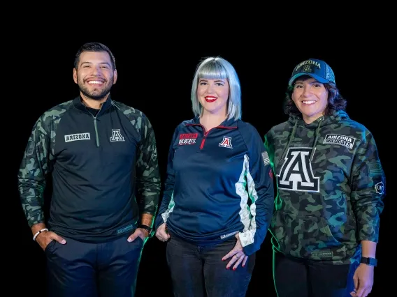 three students wearing military-themed merchandise