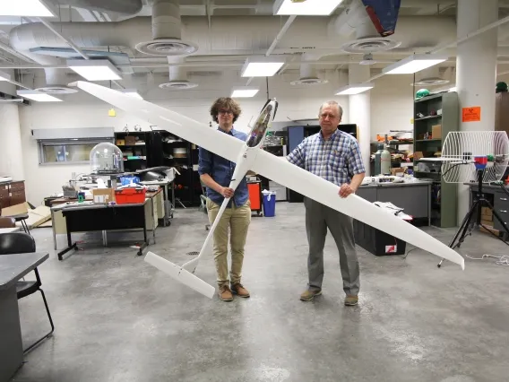 two men folding 11-foot sailplane