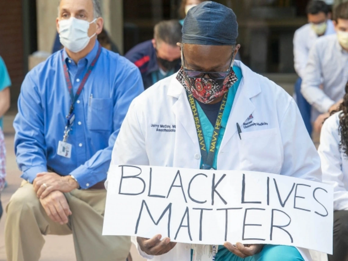 people kneeling during a protest