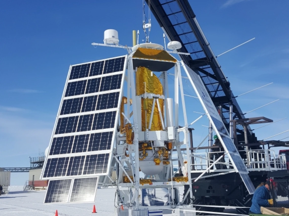 Scientists and engineers perform a hang test of the payload for the balloon-borne Stratospheric Terahertz Observatory II.