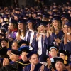 graduates standing in a crowd at commencement