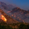 wildfires burning in a desert mountain range